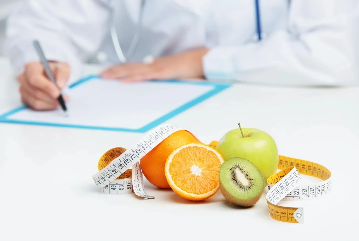 A table with fruit and measuring tape on it